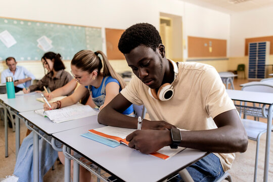 Diverse students learning and studying in classroom