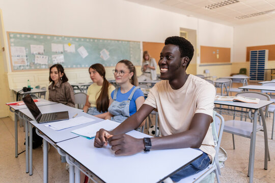 Diverse students learning together in modern classroom