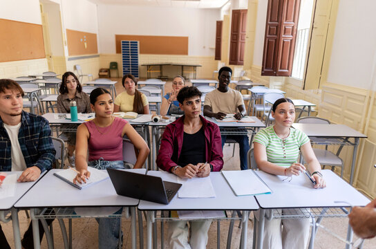 Diverse students learning in classroom, focusing on education