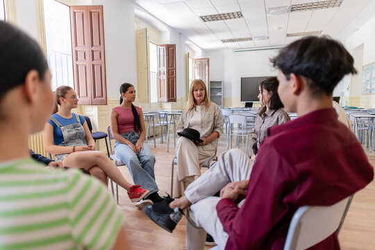 Group of young students participating in support discussion