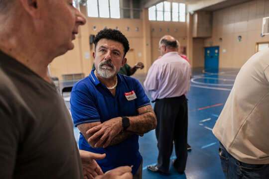 Mature man attending community event listening attentively