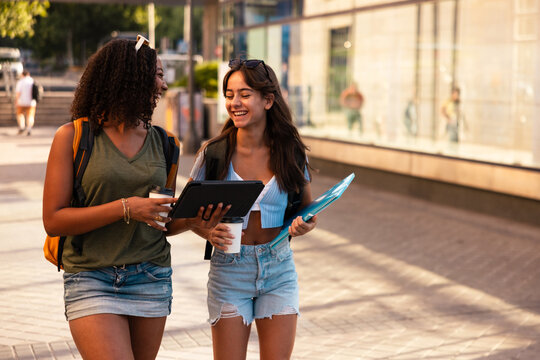 Teenage girls with school supplies enjoying a walk