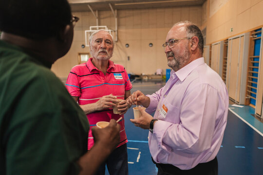 Diverse senior men conversing during a coffee break