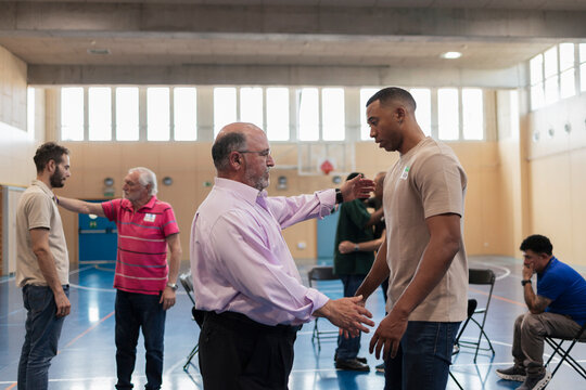Diverse men engaging in group communication and therapy workshop