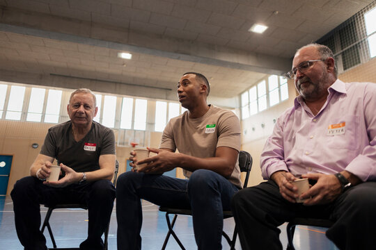 Diverse men sharing experiences in support group meeting