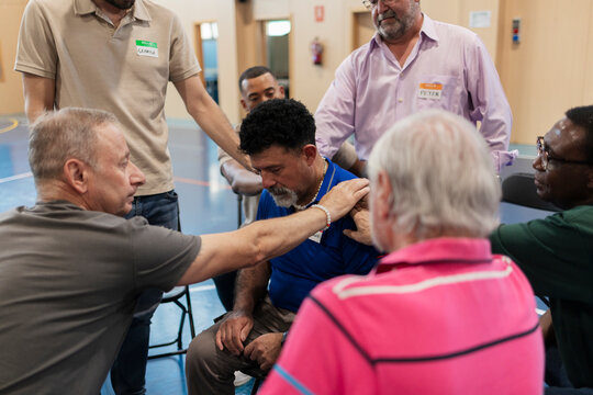 Group of diverse men offering support, comfort