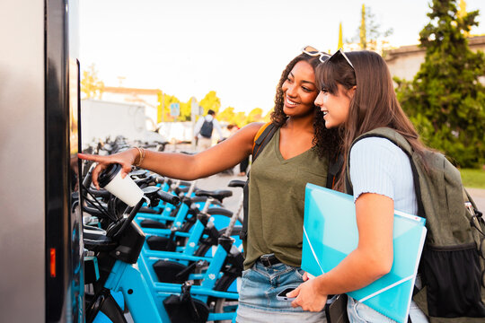 Teenage girls exploring campus with school accessories