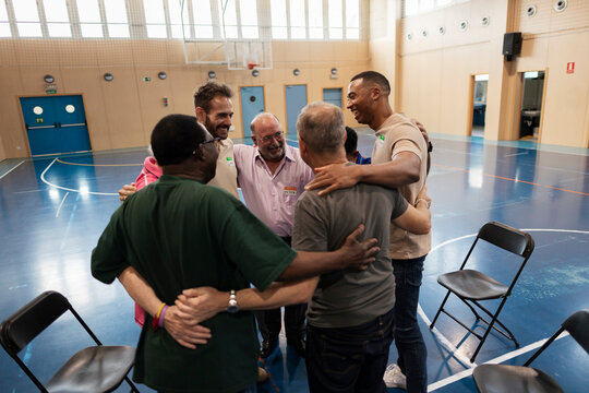 Diverse men forming huddle showing community spirit