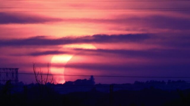 Partial solar eclipse at sunset over Rome skyline with Gasometer silhouette. Clip 05 - Sequence.