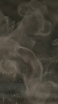 Abstract background of swirling smoke or dust particles in dark atmosphere.