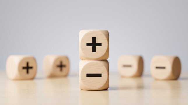 Wooden cubes with plus and minus signs on a table with evaluation business decision analysis abstract strategy balance benefit concept with choice