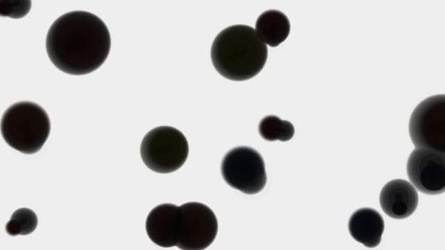 Black ink circles floating in liquid water bubbles