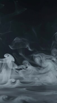 Abstract flowing white smoke patterns on a dark black background.