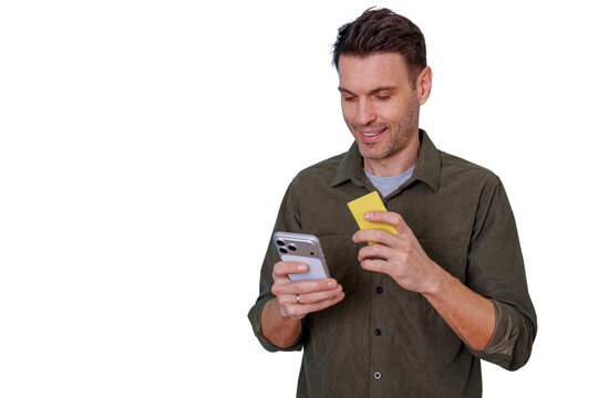 Happy man shopping online, holding smartphone and payment card for secure e-commerce transactions