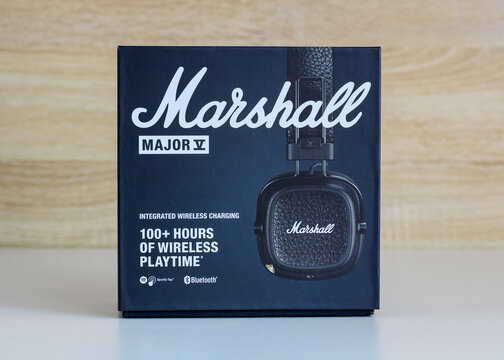 Moscow, Russia - July 14, 2026: Retail packaging of Marshall Major V wireless headphones displayed on white table against wooden background