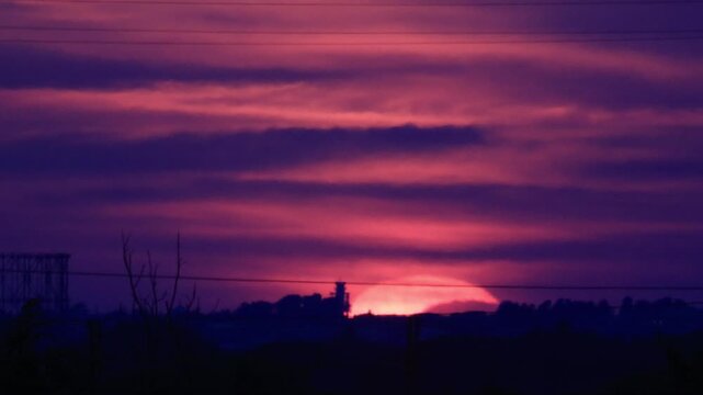 Partial solar eclipse at sunset over Rome skyline with Gasometer silhouette. Clip 07 - Sequence.