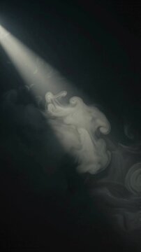 A bright beam of light cutting through thick swirling smoke in the dark.