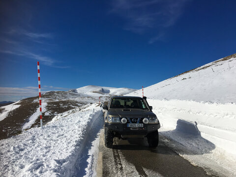 Castellar de n Hug, Spain; January 18 2017: SUV driving on snowy Bv 4031 mountain pass in Castellar de n'Hug