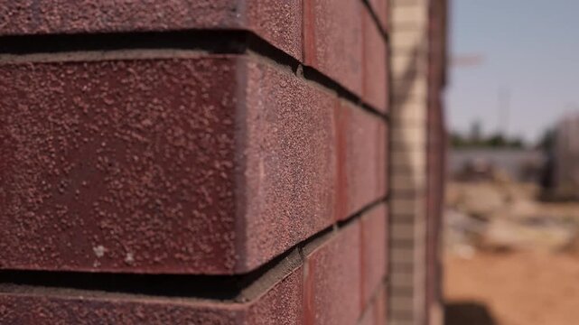 Textured red brick corner on residential building facade