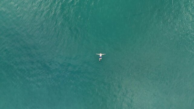 Man Floating in Turquoise Water at Playa Penca, Costa Rica &ndash; Aerial Drone 4K