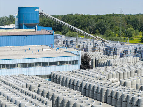 Tarnow, Poland - 31 July 2026: Aerial view of the Bruk-Bet production plant with rows of concrete pipes and industrial facilities.
