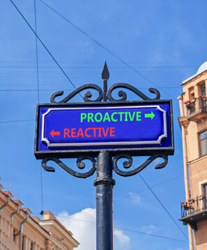 Proactive and reactive symbol. Concept word Proactive Reactive on beautiful blue road sign. Beautiful blue sky background. Business proactive and reactive concept. Copy space.