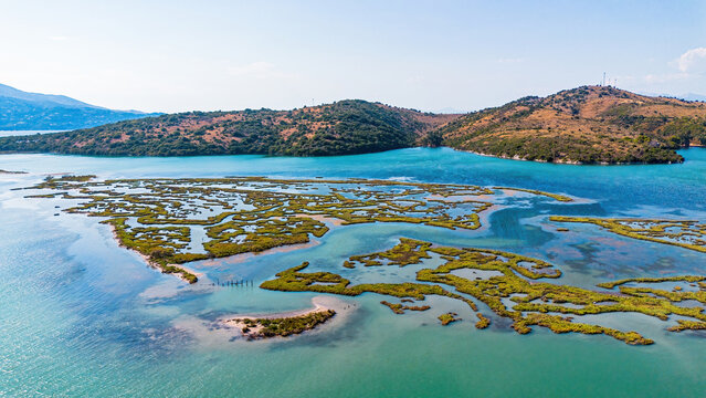 Aerial view of the wetlands, marshland, and rolling hills of Butrint National Park in southern Albania