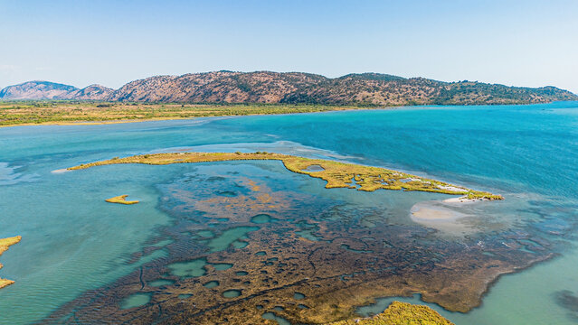 Aerial view of the wetlands, marshland, and rolling hills of Butrint National Park in southern Albania