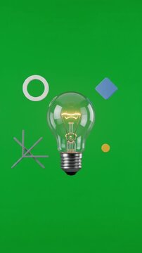 Glowing light bulb idea concept with abstract geometric shapes on green screen background vertical video mockup