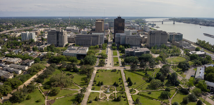 Baton Rouge, Louisiana, United States - 28 March 2023: Aerial view of the downtown skyline, the Mississippi River, and the lush green grounds of the State Capitol area.