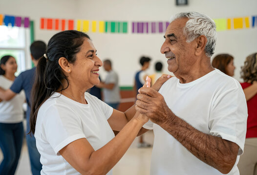 Happy senior couple dancing together in a community center, enjoying an active lifestyle and social interaction