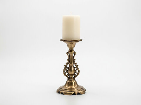 Vintage ornate brass candlestick with unlit white pillar candle isolated on white background 3D rendering