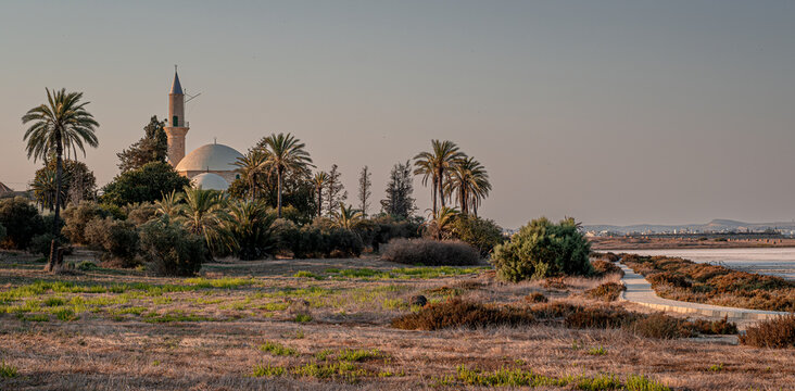 The famous Hala Sultan Tekke, as seen at sunset, also known as the Mosque of Umm Haram, is one of the most significant Islamic monuments in the world, located on the west bank of Larnaca, Cyprus