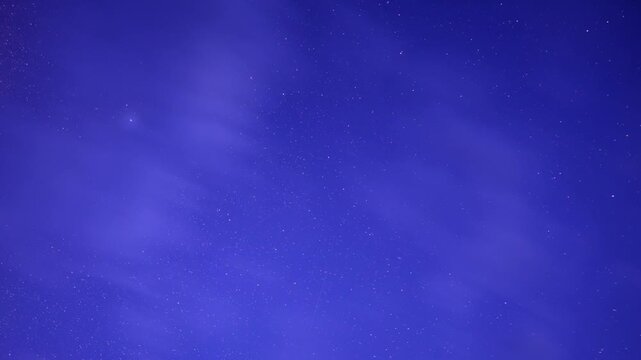 Night sky timelapse with clouds moving in front of a sky full of clouds
