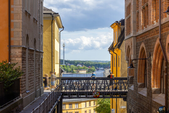 Stockholm city view with walking people on footbridge