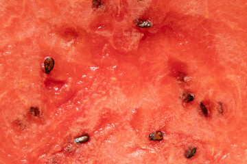 A close-up of juicy watermelon flesh with seeds, related to fresh fruit, summer food, dessert © Виктория Котлярчук