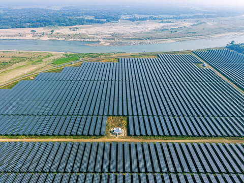Mymensingh, Bangladesh - 30 January 2026: Aerial view of HDFC SinPower Limited solar power plant with rows of solar panels and a central transformer station near the river.