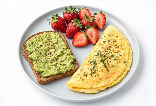 Delicious healthy breakfast featuring avocado toast and omelette with fresh strawberries on plate