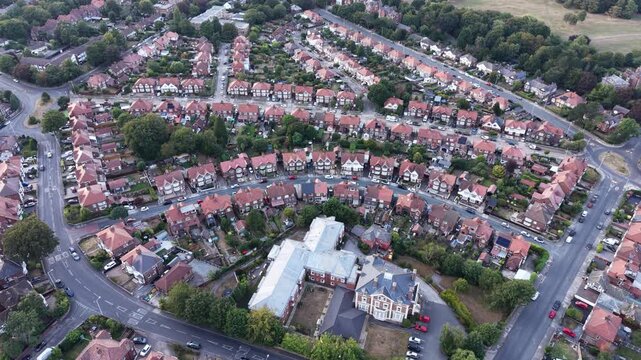 Aerial drone 4K footage showing Wirral housing blocks glowing under warm daylight with vivid natural tones Wirral