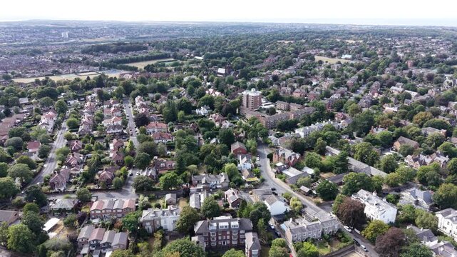 Aerial drone 4K footage showing Wirral housing blocks illuminated by warm afternoon sky light with bright natural tones Wirral
