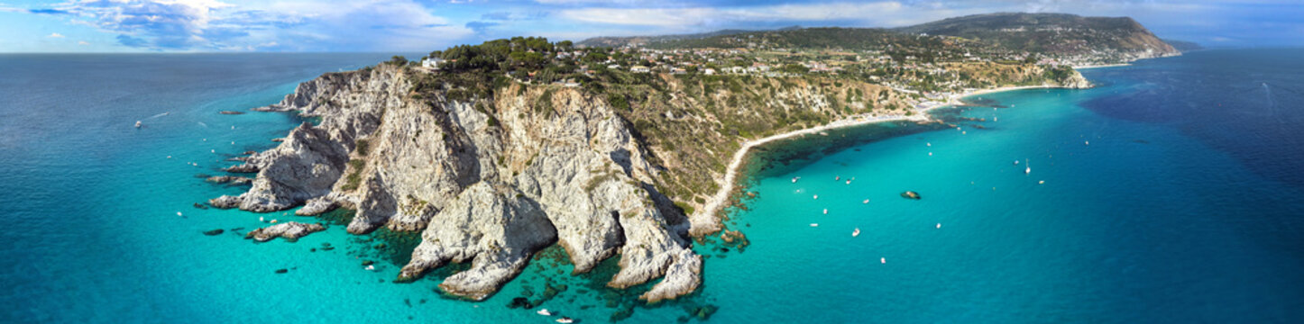 Capo Vaticano Calabria Italy 4:1 aspect ratio panorama ultra high resolution. Drone view of dramatic cliffs and turquoise sea with boats. Italian tropical coastline fine art world print