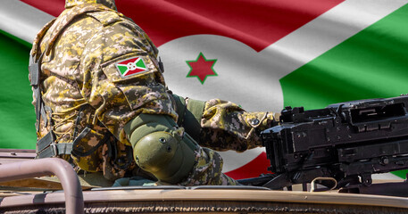 Naklejka premium Burundi flag with soldier at machinegun turret