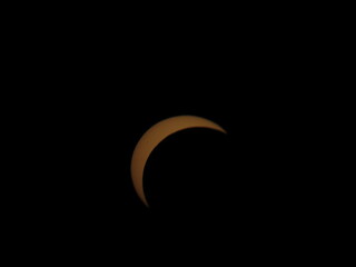 Abstract night scene from Mioglia, Italy, featuring glowing orange crescent rings against a black background. © Roberto