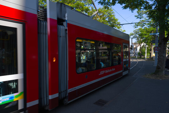 Red tram number 9 with RHB railway livery at Schwamendingerplatz tram station at Swiss city of Z&uuml;rich on a summer evening. Photo taken August 14th, 2026, Zurich, Switzerland.