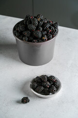 a bucket of blackberries on light background © JuliaLavleis
