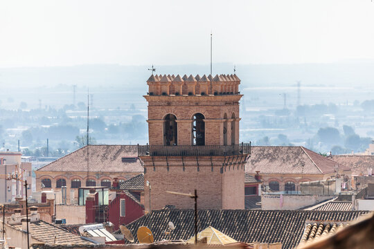 The bell tower of the Church of Santiago el Mayor in Totana, Region of Murcia, Spain, rising above the rooftops 