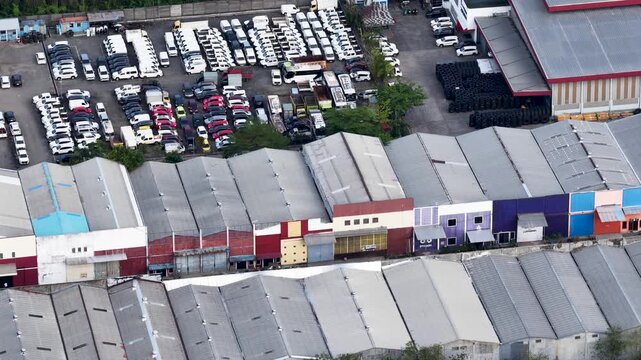 Many cars parked in an industrial area with long storage warehouses in Banjarbaru South Kalimantan
