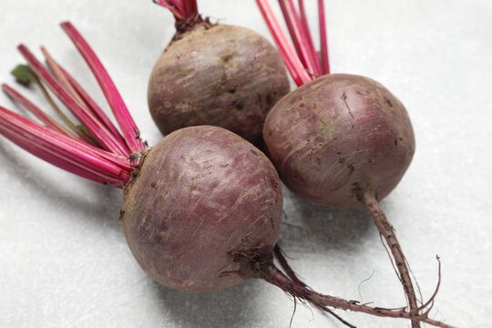 Whole young beets on gray table, closeup