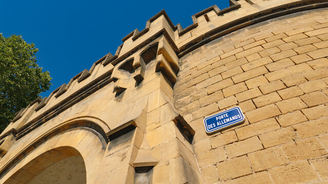 Porte des Allemands historic stone fortification rising against a clear blue sky
