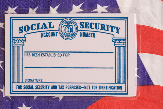 Moscow, Russia - August 14, 2026: A US Social Security card placed on a background of United States dollar banknotes, illustrative editorial.
